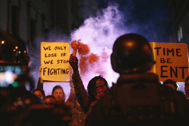 istock Group of activists protesting with smoke grenades 1218557974
