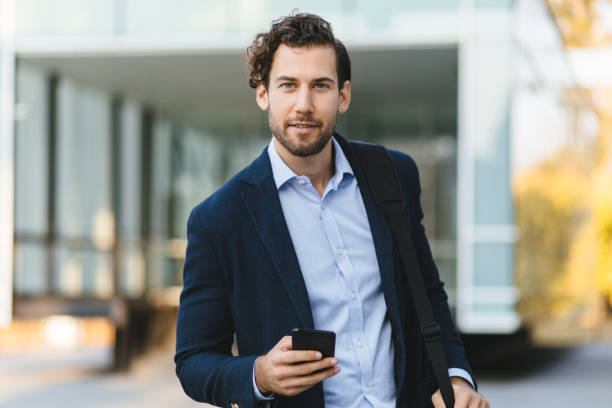 istock Young businessman typing text message on his way to work 1218559050