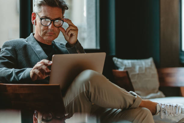 istock Mature male executive working in office lounge 1218559625