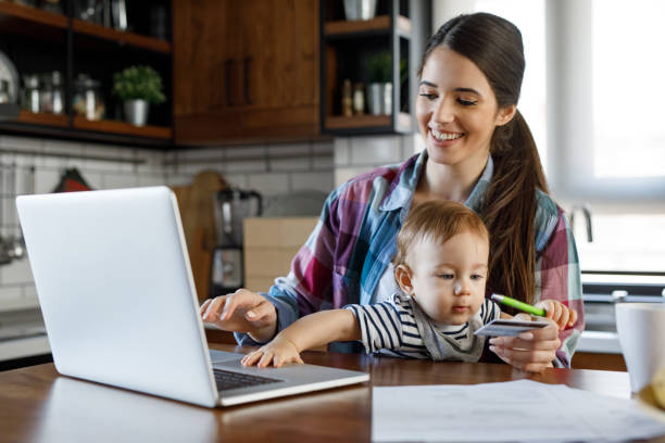 istock Young mother juggling work and child care 1218559669