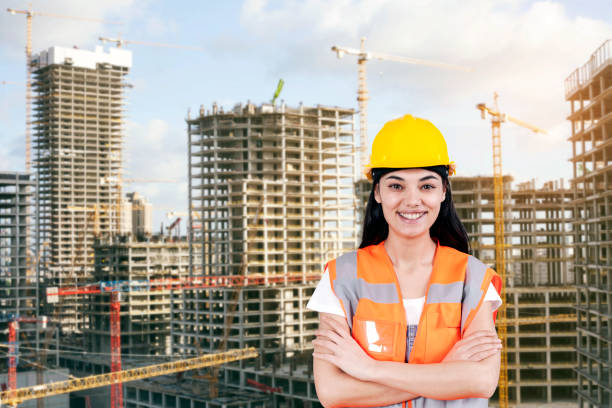 istock Young woman civil engineer on construction building background. Evolution construction concept. 1218560538