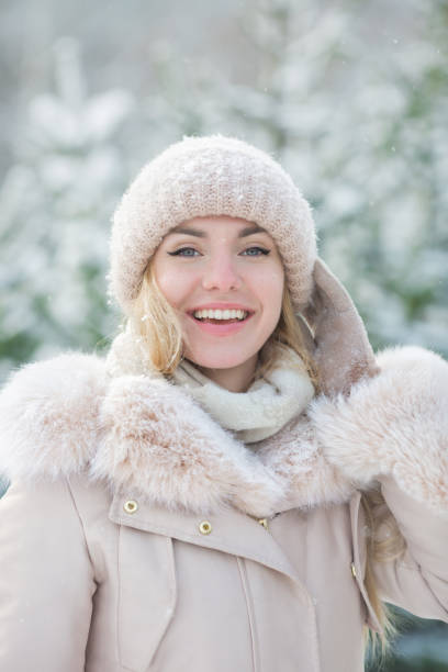 portrait of a cute girl in a beige jacket in a winter day