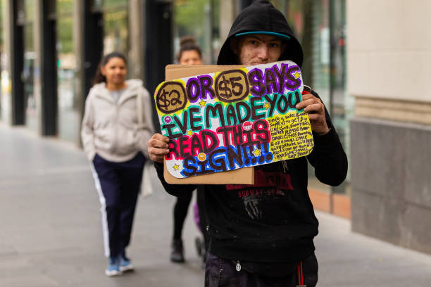 COVID-19 Crisis in Melbourne, Melbourne, Australia Melbourne, Australia, 12 April, 2020. A homeless man holds a sign begging for money during the  COVID-19 Crisis in Melbourne. south yarra stock pictures, royalty-free photos & images