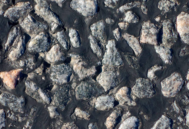 istock Crushed granite stone, an asphalt  ingredient to provide more tire friction while driving. 1218563693