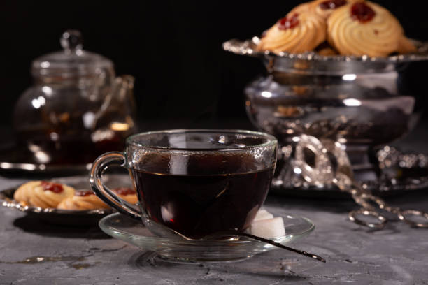 istock Tea and cookies in vintage utensils on a gray background 1218564295