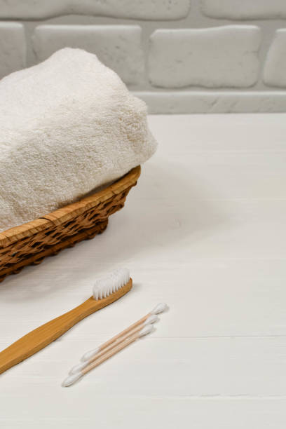 istock Zero waste concept. Toothbrush and towel on a white background. Eco-friendly bamboo toothbrush. Place for an inscription 1218564665