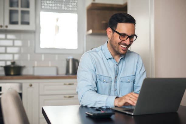 istock Businessman working on laptop at home. 1218564703