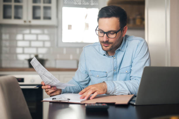 istock Young businessman working from home while holding a sketch in his hand. 1218564738