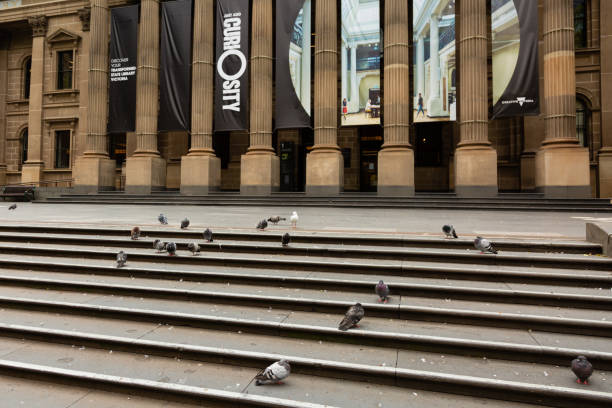 COVID-19 Crisis in Melbourne, Melbourne, Australia Melbourne, Australia, 12 April, 2020. One of the most popular meeting places in the CBD, The State Library is closed, and its steps empty. Only Pigeons remain during the  COVID-19 Crisis. south yarra stock pictures, royalty-free photos & images