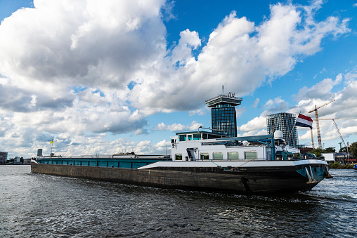 Large cargo ship sailing on the river in Amsterdam, Netherlands