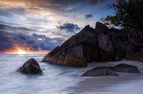 istock Beautiful sunset on the beach with typical granite rock formations on Praslin island , Granitic Seychelles , archipelago country in the Indian Ocean 1218566194