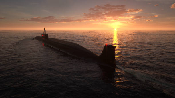 istock Heavy atomic submarine in ocean at sunset 1218567204