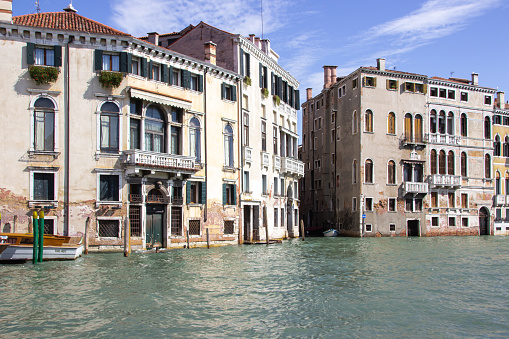 Venice, Italy - September 28, 2015 : Water channels of Venice city. Facades of residential buildings overlooking the Grand Canal in Venice, Italy.