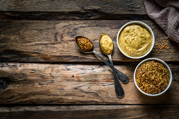 istock Whole grain and Dijon mustard shot from above on rustic wooden table. Copy space 1218568276