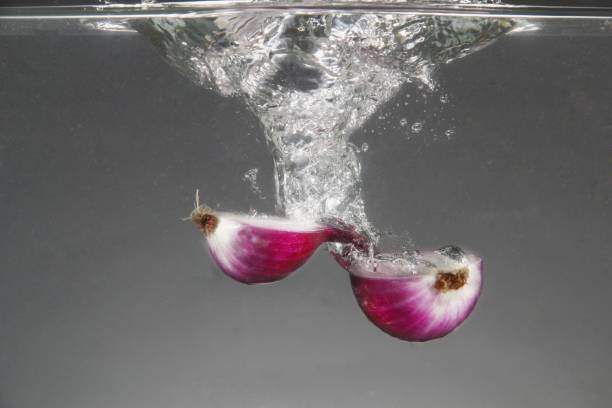 Photo of fresh red onion dropped in water