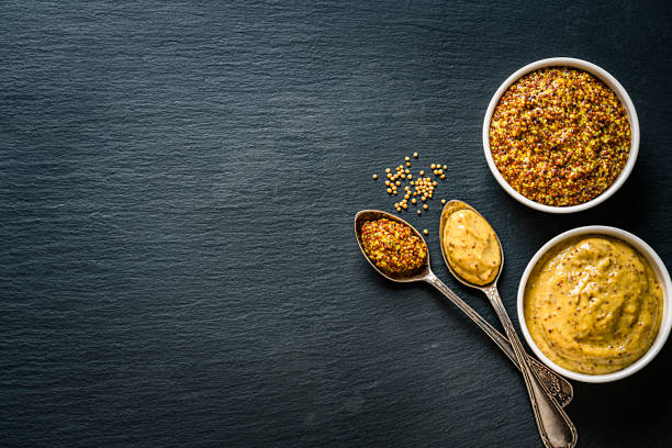 istock Whole grain and Dijon mustard shot from above on dark slate background. Copy space 1218569154