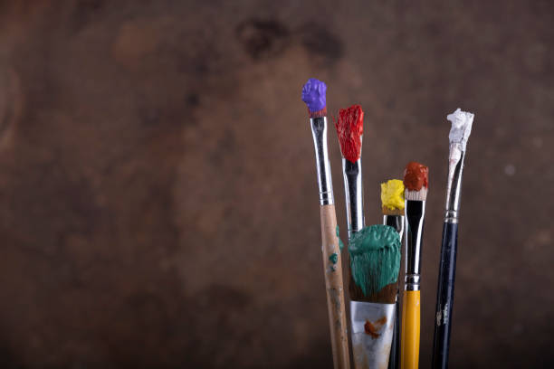 istock Paint brushes in front of blurred canvas 1218569173