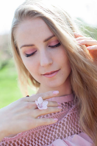 istock A woman blonde holds a ladybug on her hand 1218569264