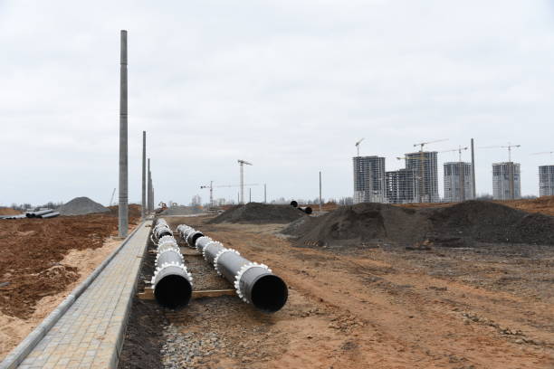 istock Cast iron sewer pipes for laying an external sewage system at a construction site. Sanitary drainage system for a multi-story building. Civil infrastructure pipe, water lines and storm sewers 1218571260