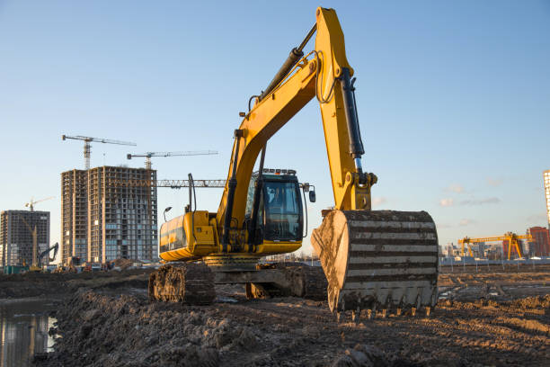 istock Track-type excavator during earthmoving at construction site. Backhoe digging the ground for the foundation and for laying sewer pipes district heating. Earth-moving heavy equipment 1218571264