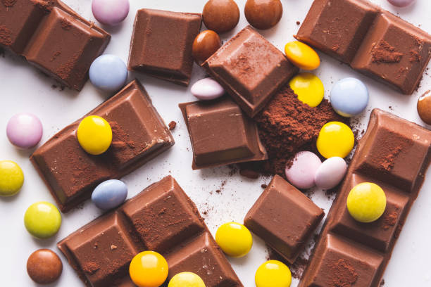 istock chocolate and skittles on a cocoa powder 1218572126