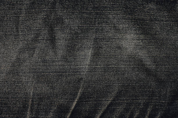 texture de jeans en denim noir pour le fond. jeans en denim avec vieux déchiré de la conception de jeans de mode - textile canvas torn textured photos et images de collection