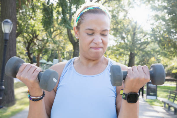 istock woman exercising outside in the park 1218573410