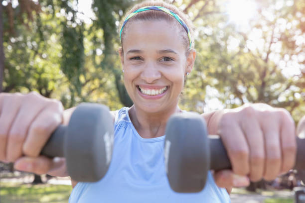 istock woman exercising outside in the park 1218573427