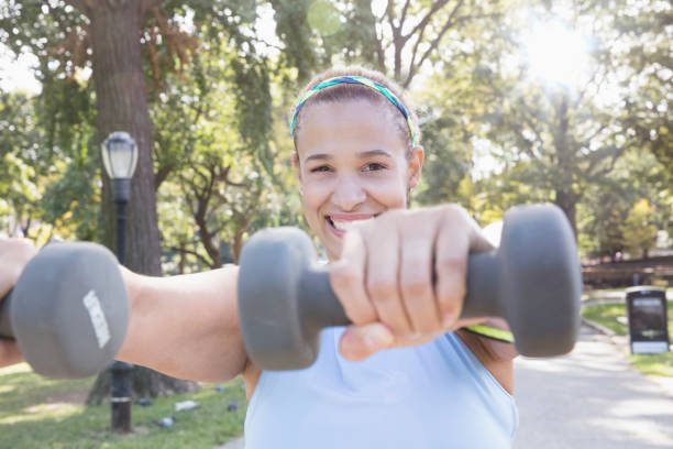 istock woman exercising outside in the park 1218573430