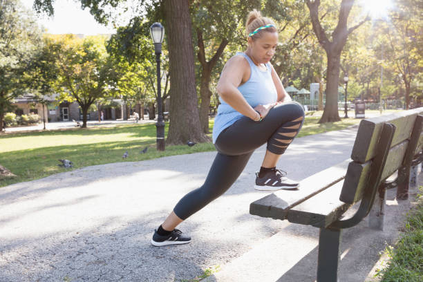 istock woman exercising outside in the park 1218573471