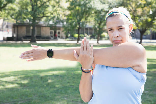 istock woman exercising outside in the park 1218573492