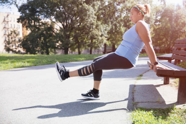 istock woman exercising outside in the park 1218573599