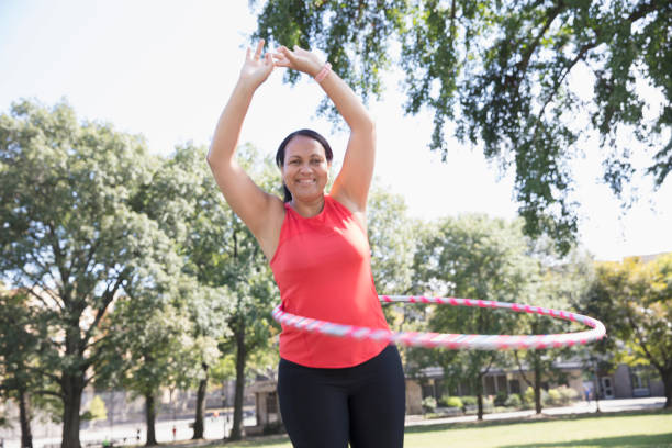 istock woman exercising outside in the park 1218573623