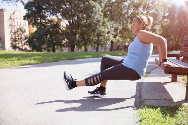 istock woman exercising outside in the park 1218573688