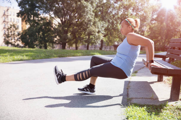 istock woman exercising outside in the park 1218573729