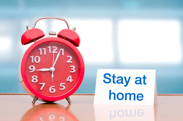 istock Alarm clock with stay at  home message 1218574219