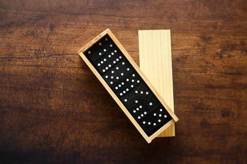 Dominos on wooden table.