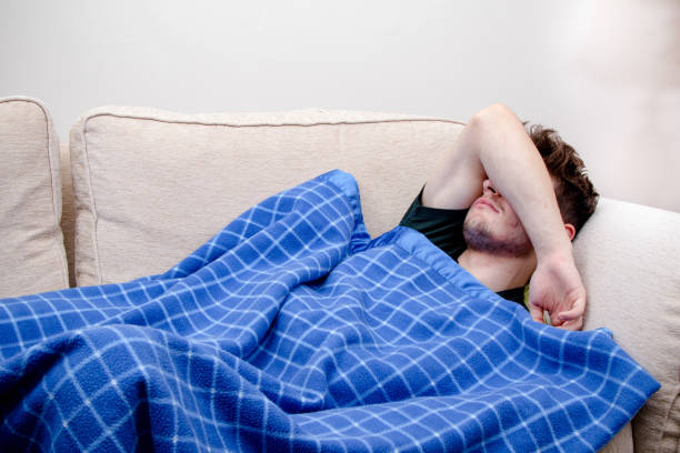 istock A young adult man on a sofa 1218576813