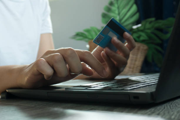 istock Hands holding credit card and using laptop. Online shopping. work from home concept 1218578740