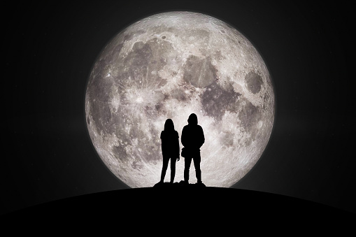 Silhouette of man and women  Looking at the moon with hope Fulfillment in love. Elements of this image furnished by NASA.