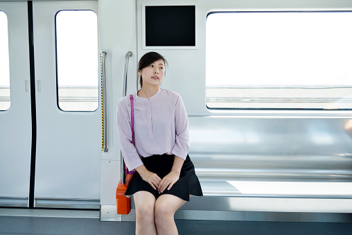 Woman sitting in the subway train