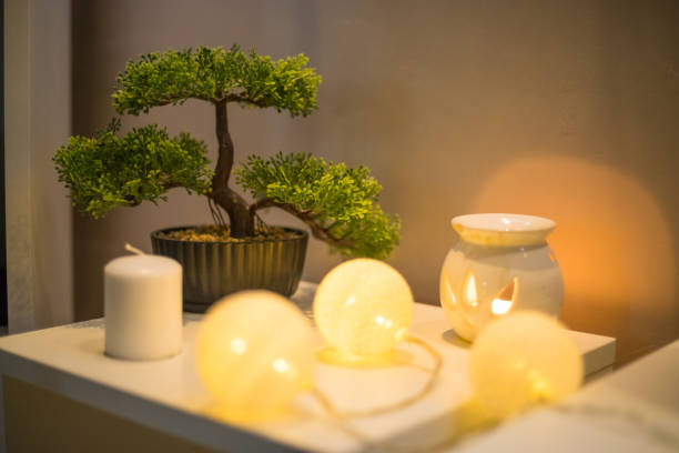 istock Bonsai tree with candle on white table in bedroom 1218580330