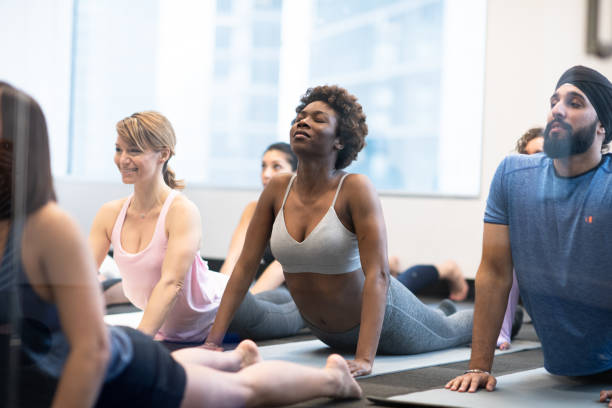 istock Group of diverse people exercising together 1218580493