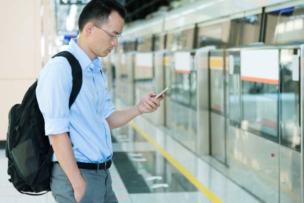 istock Businessman using smart phone at subway station 1218581595