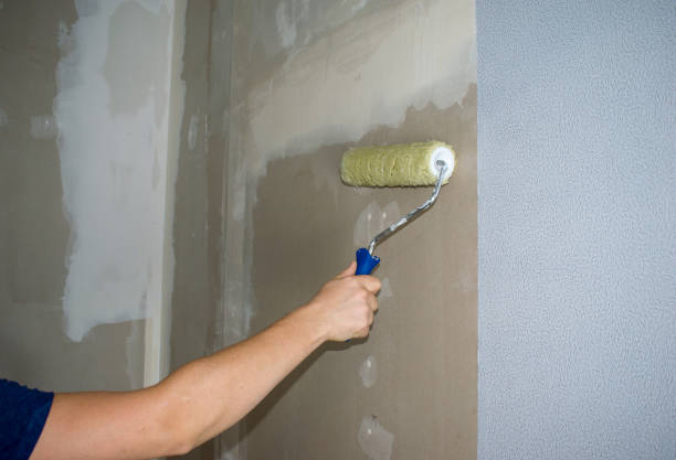 istock Putting glue roller. Men's hand holds instrument. 1218582097