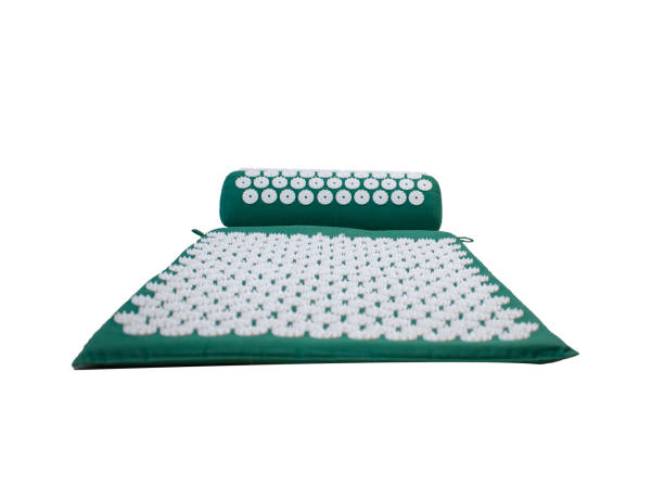 Acupressure mat and pillow set for back and neck pain relief and muscle relaxation isolated on white background. Relieves stress, pain.