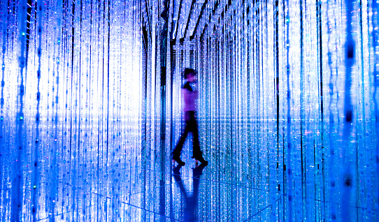 Woman walking in the blue lights.