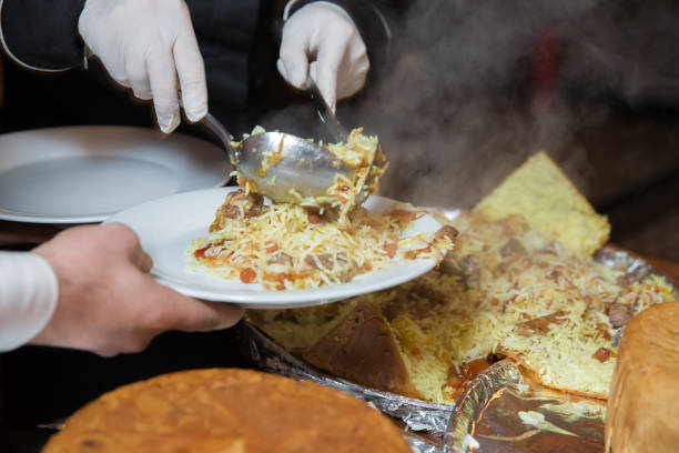 istock Khan pilaf in a pita. Traditional oriental dish on tableware Azerbaijan with fire on a table in restaurant .the chef cuts off the drill. Shah pilaf. 1218583790