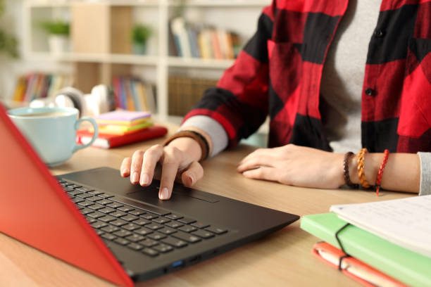 Student girl hand e-learning on laptop at home