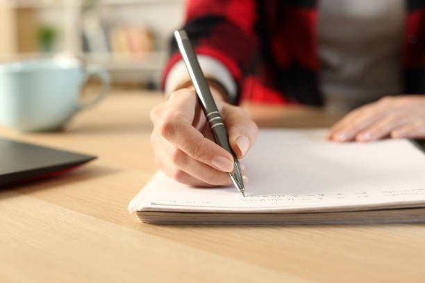 istock Student girl hands writing notes on notebook at home 1218586057